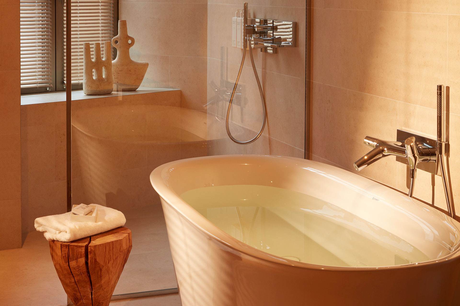 A spacious bathroom with a bathtub and a glass-enclosed shower.