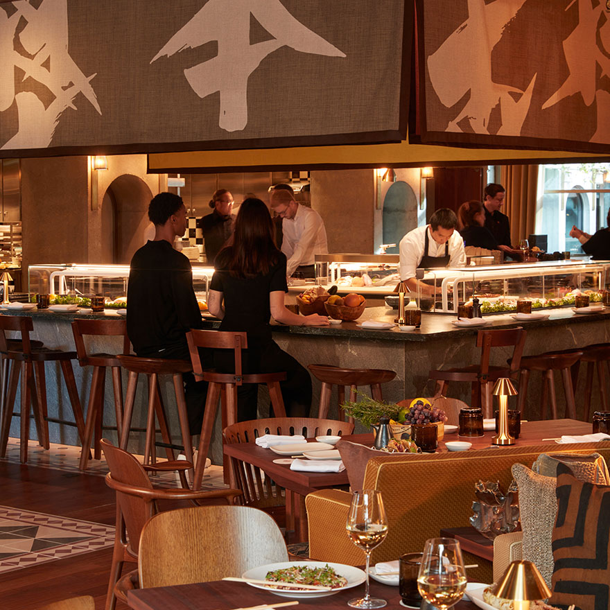 a busy sushi bar at Morimoto with diners sitting at the bar