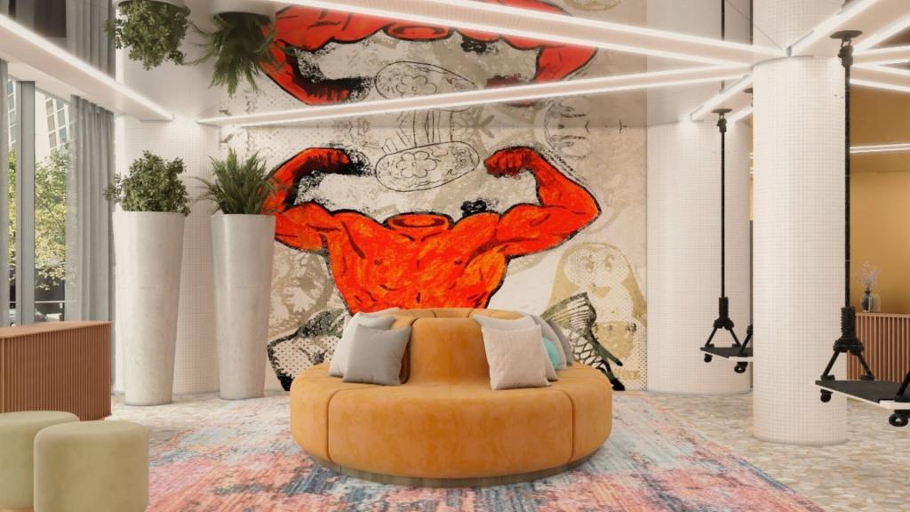 Hotel lobby with round sofa, patterned rug, and artwork with a red man