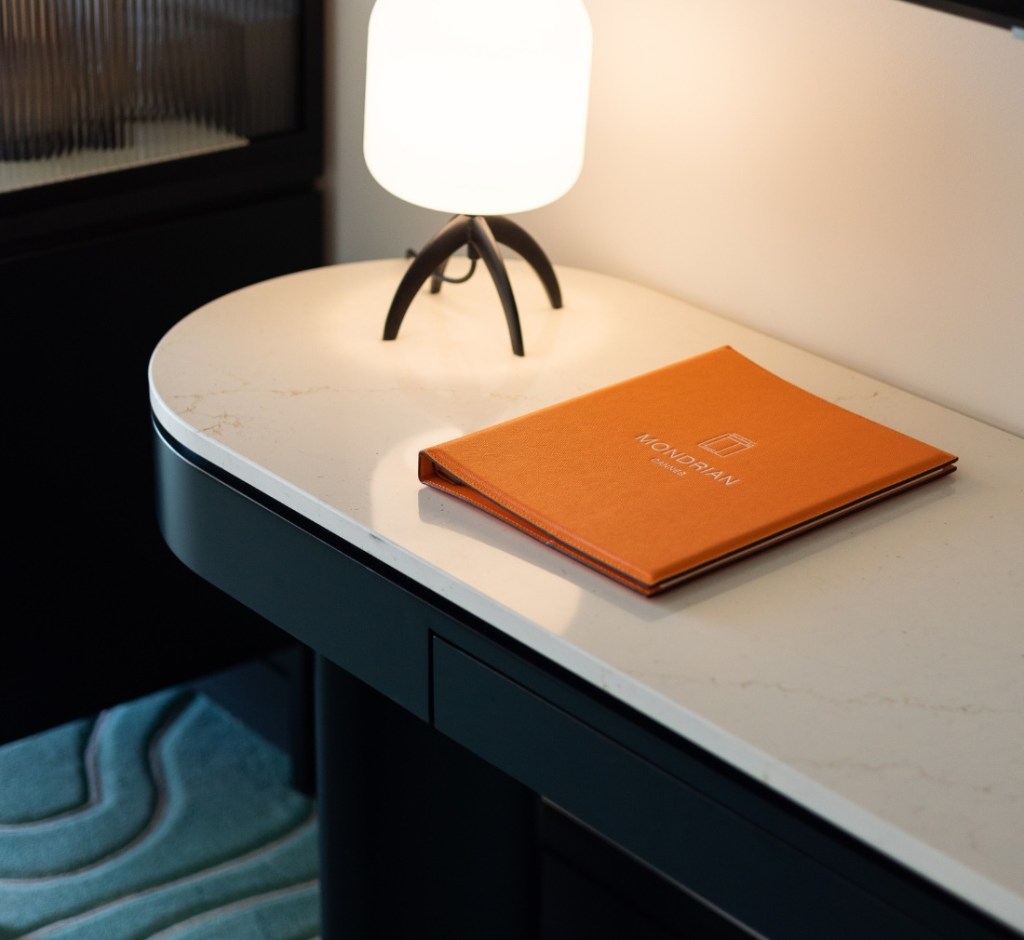 Desk with lamp and orange book.