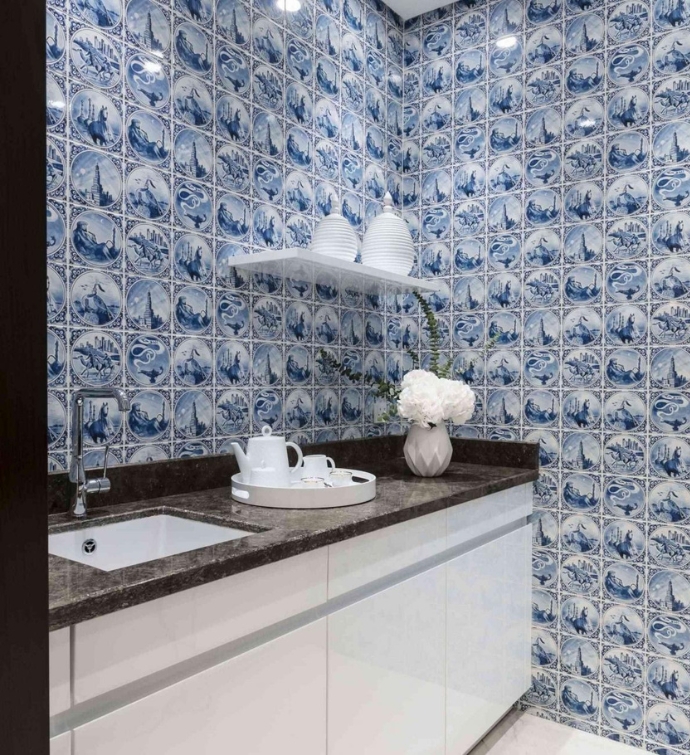 Kitchen area with a sink and white and blue patterned wallpaper