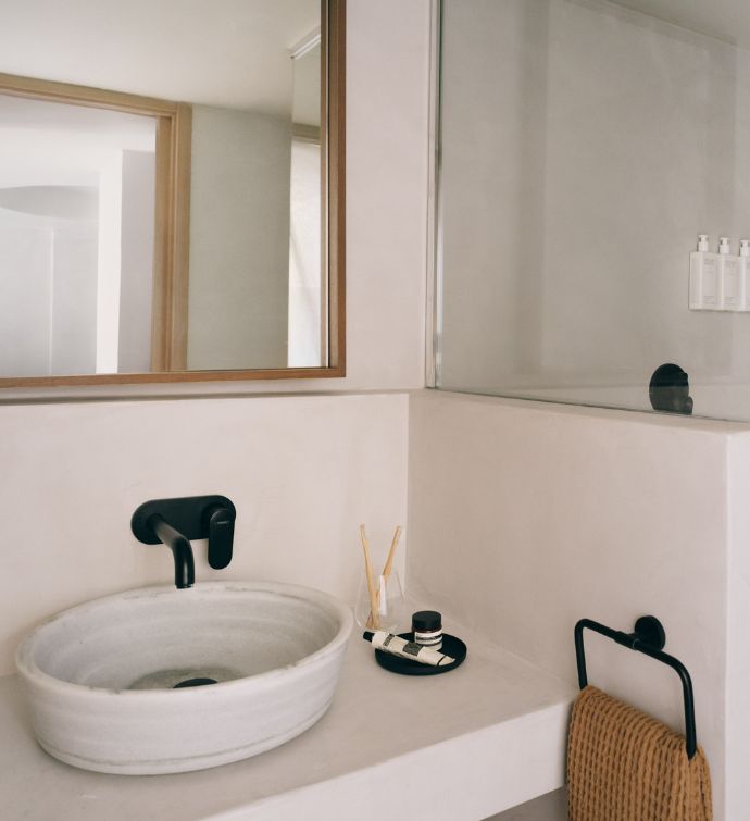 Bathroom with white countertops, white sink, and large square framed mirror