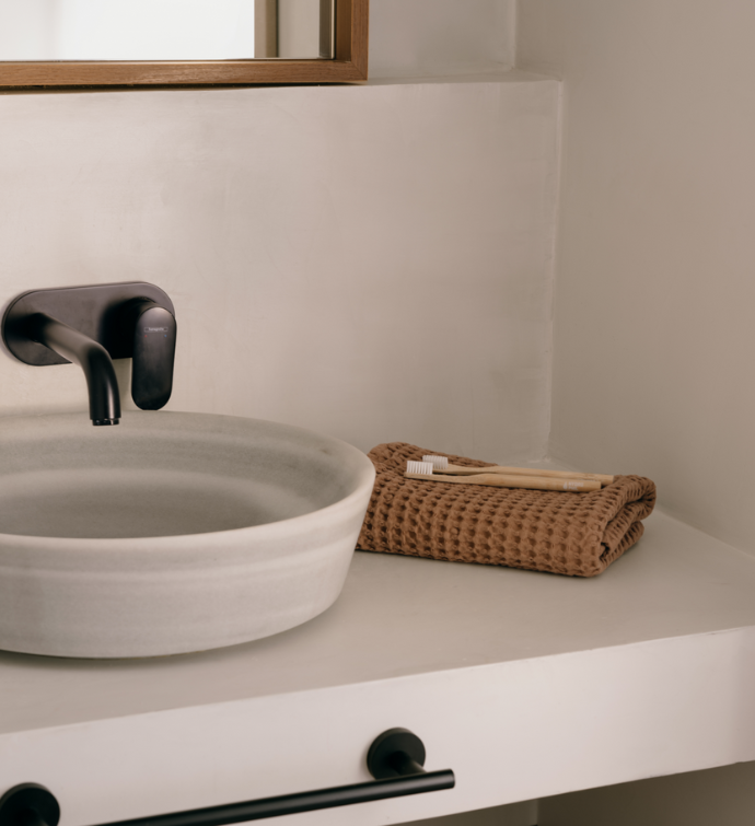 a naturally designed batrhoom with a large sink with modern finishes