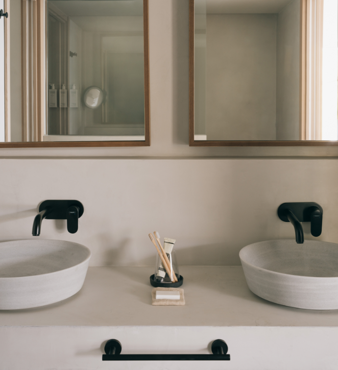 a vanity with two sinks and a large mirror