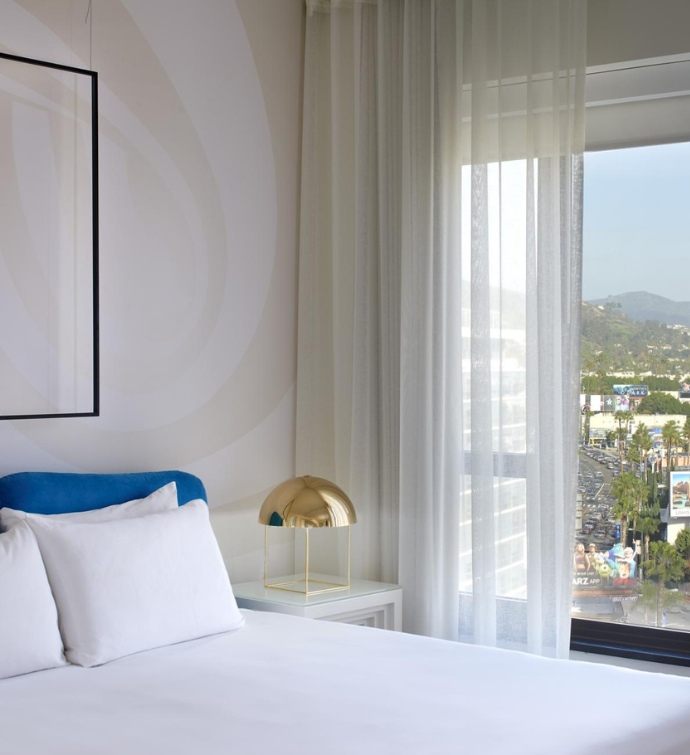 Bed with nightstand and gold lamp with views of Los Angeles