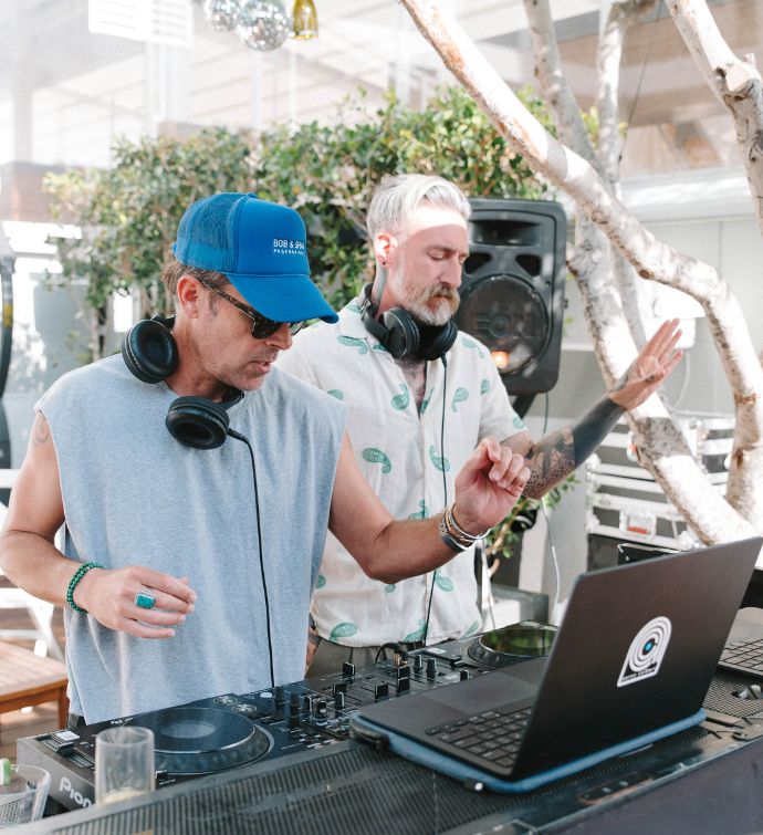 Two DJs in front of a laptop at Skybar LA