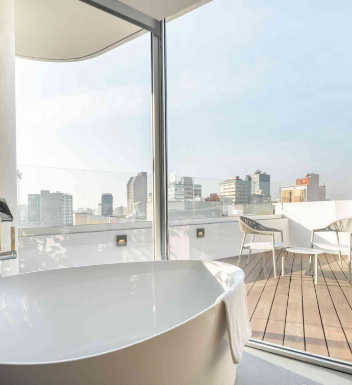 a large soaking tub with views of the terrace