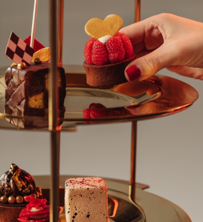 Layered serving tray filled with desserts at Alice in Wonderland afternoon tea