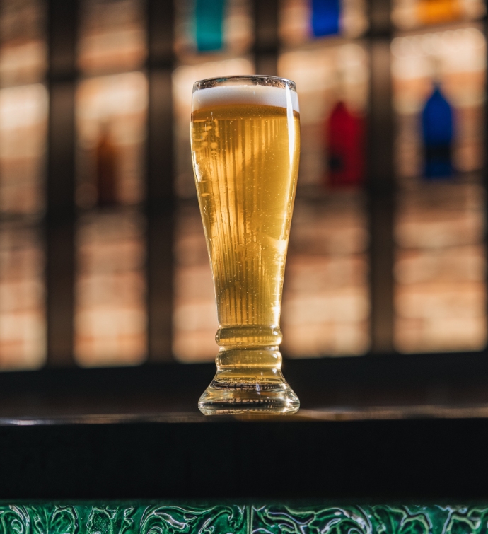 Tall beer on the bar at Hudson Tavern Doha