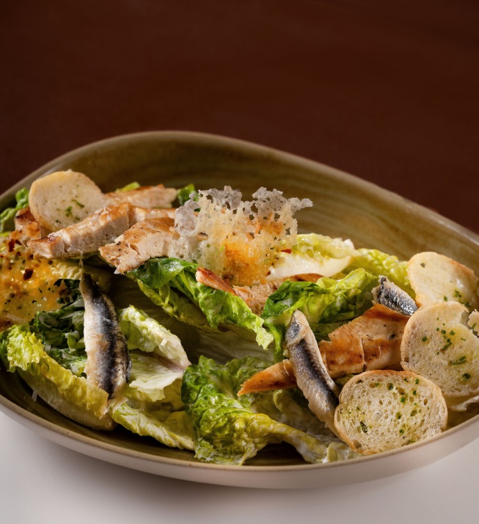 Caesar salad with croutons, anchovies and parmesan crisps