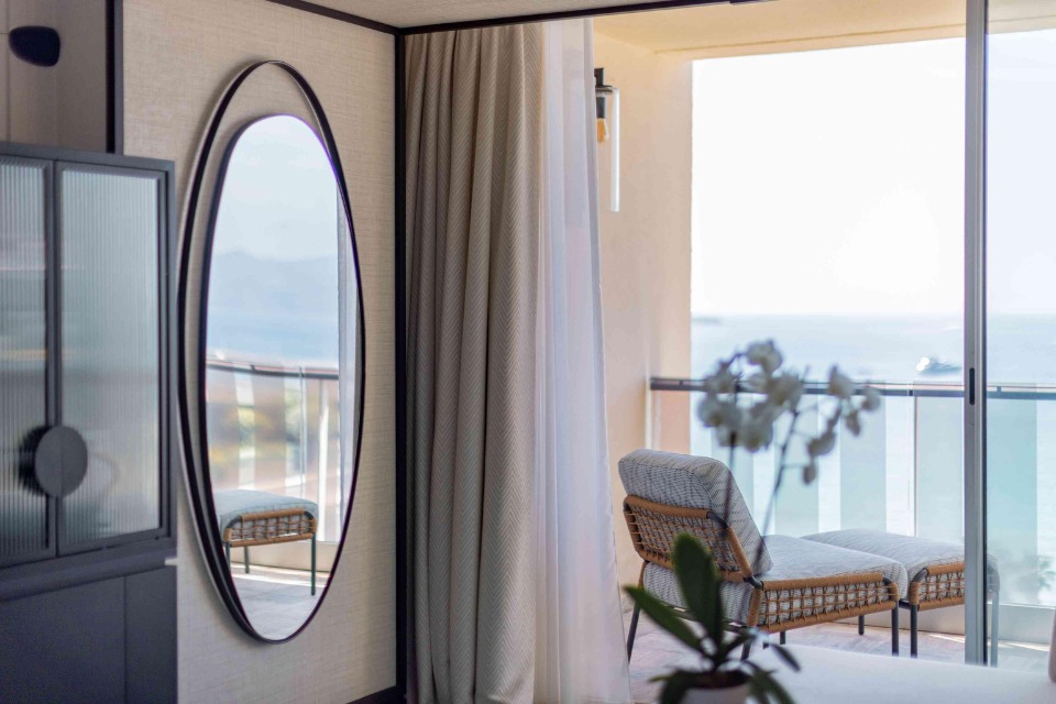 Mondrian Cannes guestroom with mirror and a balcony