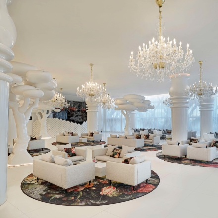 Ellamia Doha interior with white couches and chandeliers