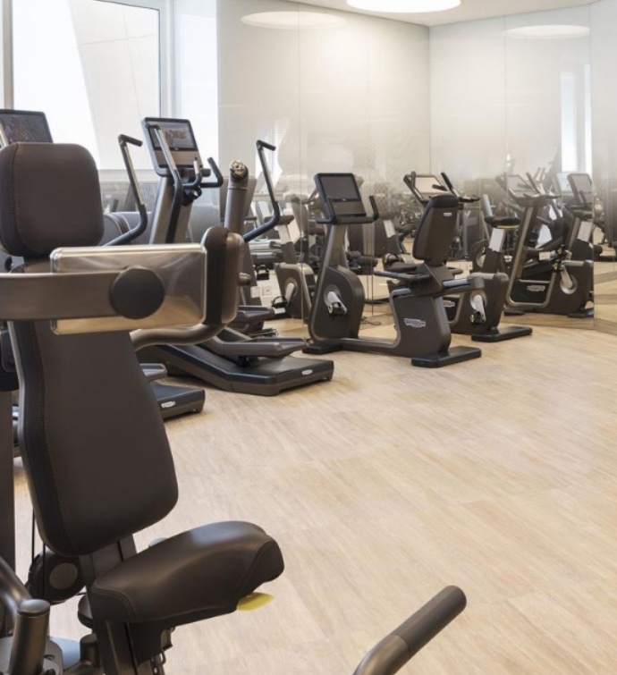 Fitness center at Mondrian Doha with ellipticals and weight lifting machines