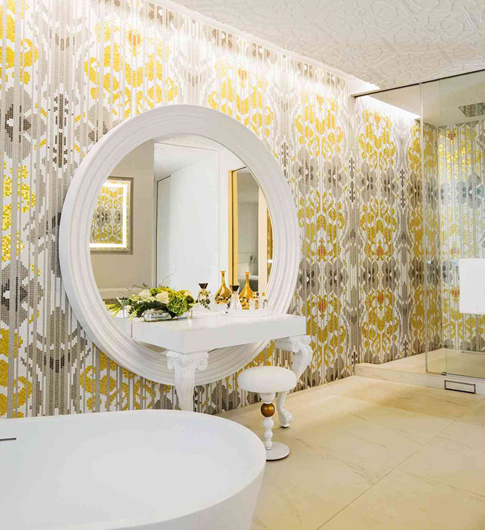 A bathroom with a spacious mirror and a sink.