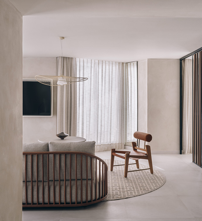 A modern living room with a wooden chair and a television.