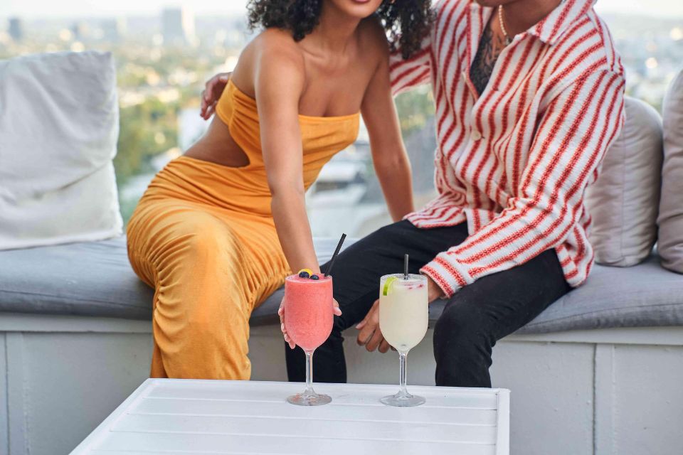 Man and woman embracing and enjoying cold cocktails