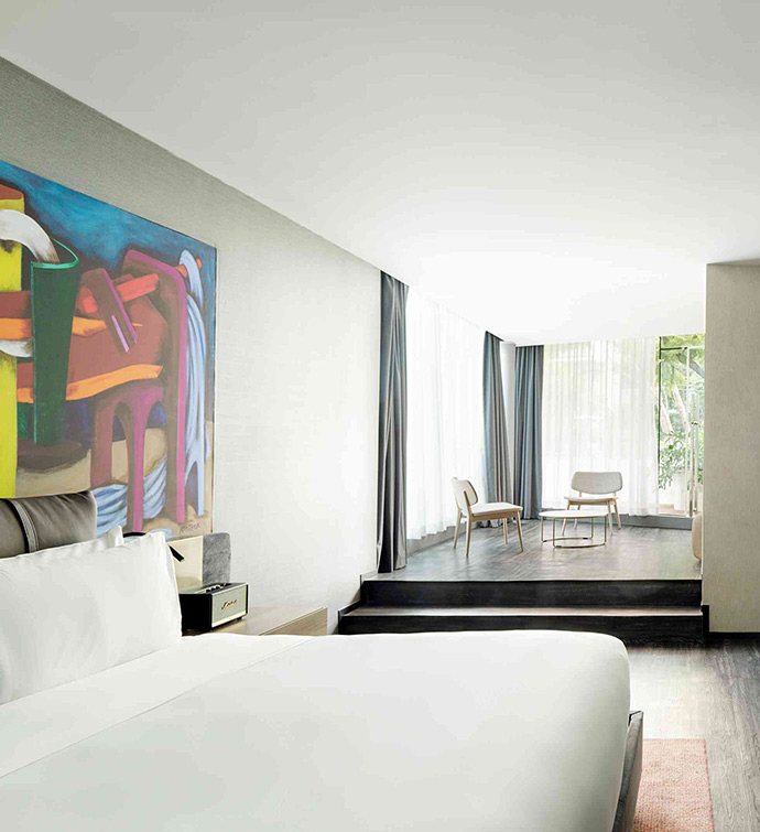 A hotel room with a captivating painting adorning the wall