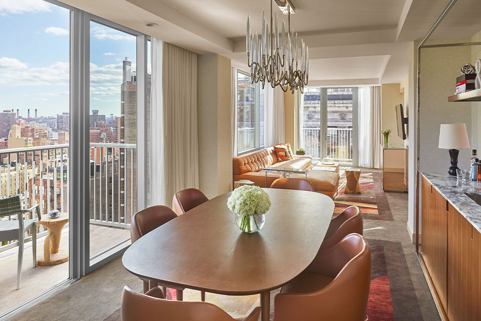 A cozy living room with a dining table and chairs.