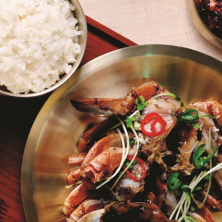 a delicious meat entree in a silver bowl with white rice in the adjacent silver bowl