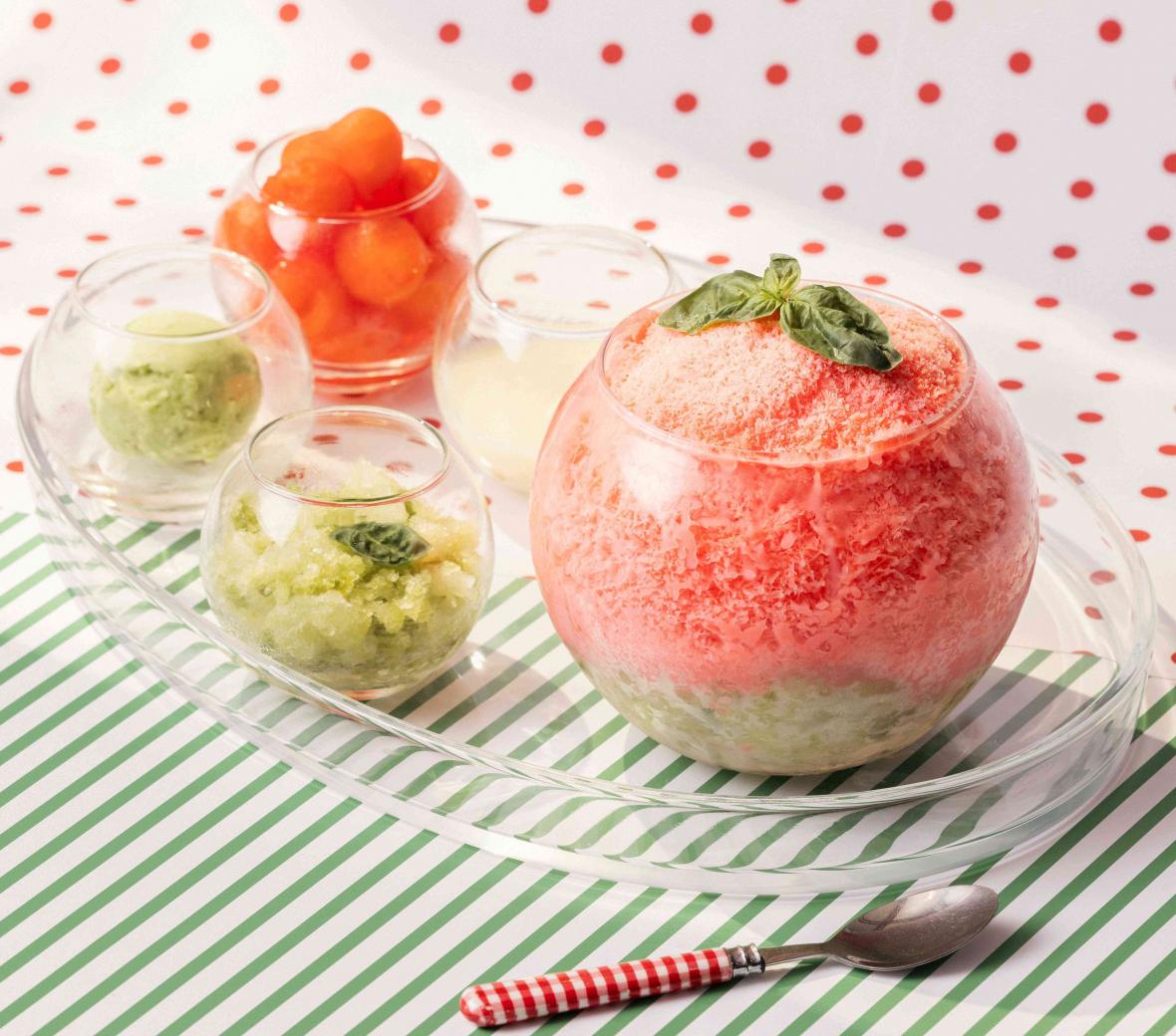 Pink bingsoo on a clear plate with multiple toppings