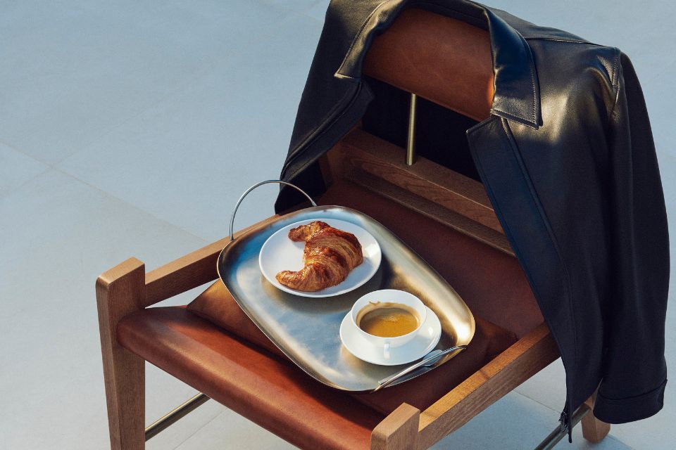 Chair with a leather jacket, pastry and coffee