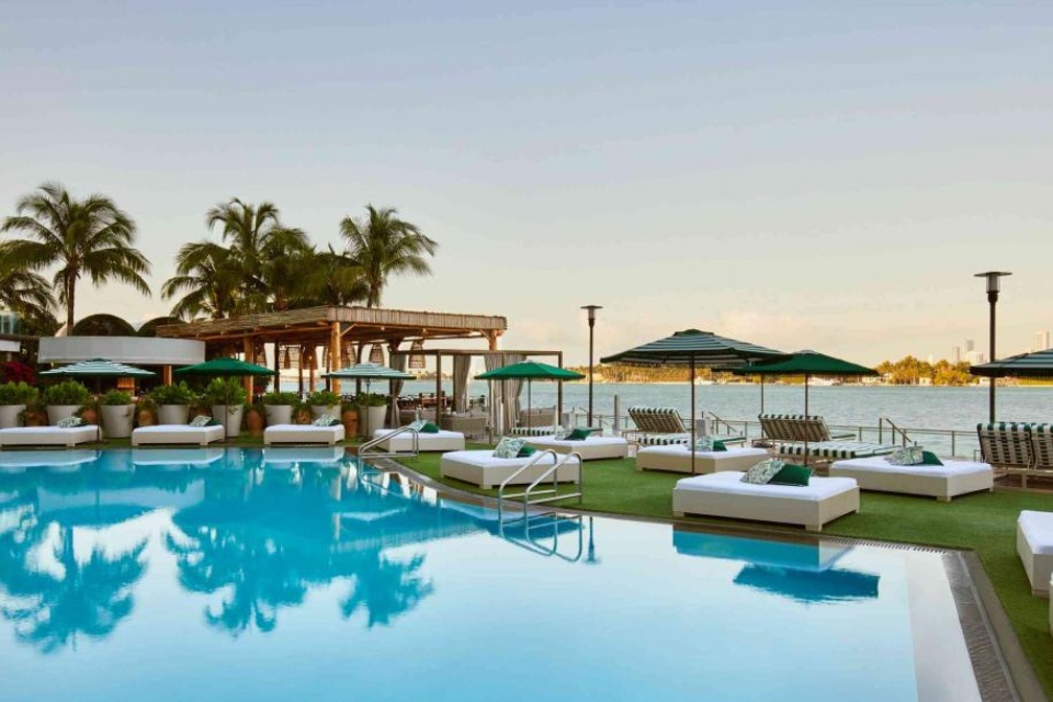 Baia Beach Club with a pool and daybeds overlooking the water