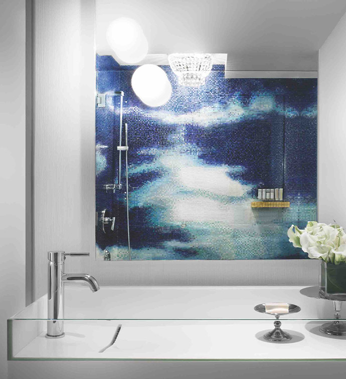 A bathroom with a serene blue and white mural adorning the wall.