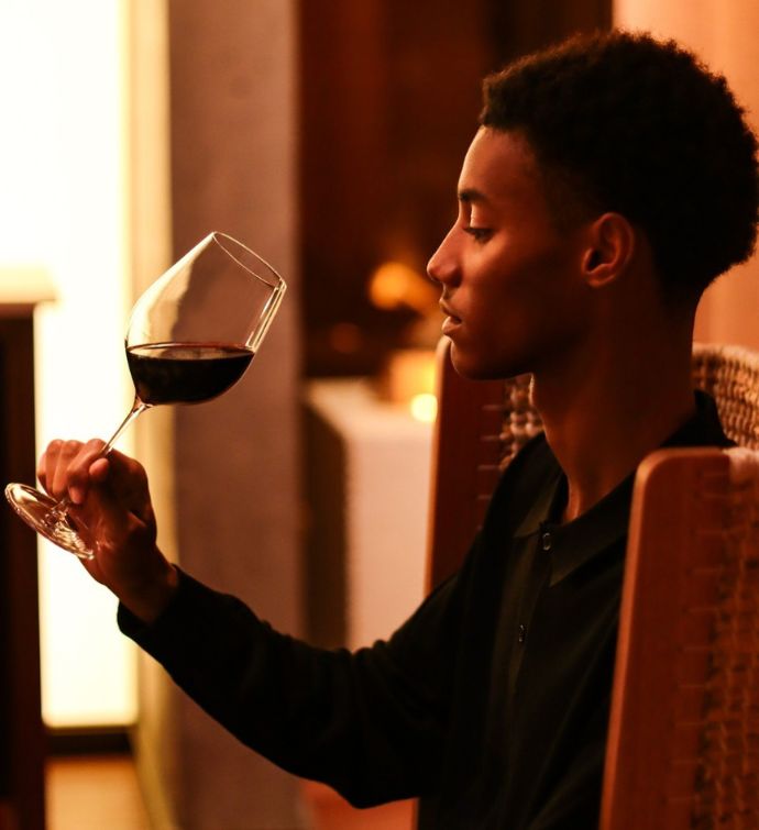 Man drinking a glass of red wine at Morimoto Bordeaux