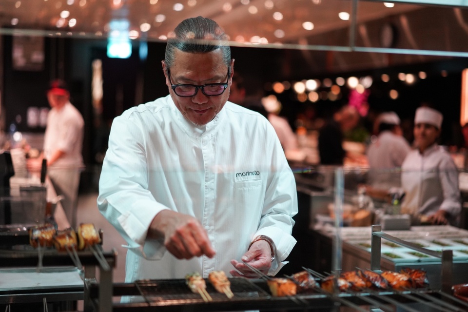 Chef Morimoto preparing sushi at Morimoto Doha