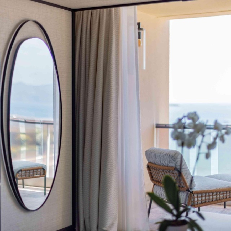 Mondrian Cannes guestroom with mirror and a balcony