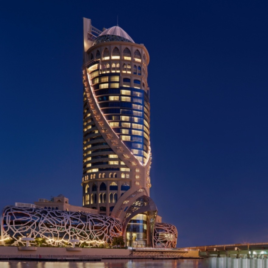 Exterior of Mondrian Doha hotel illuminated at night