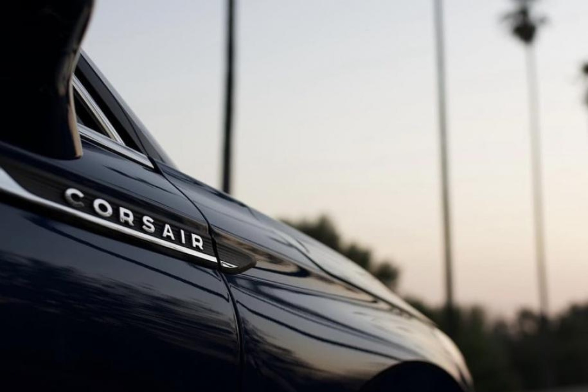 Image of Lincoln Corsair black car with palm trees in the background