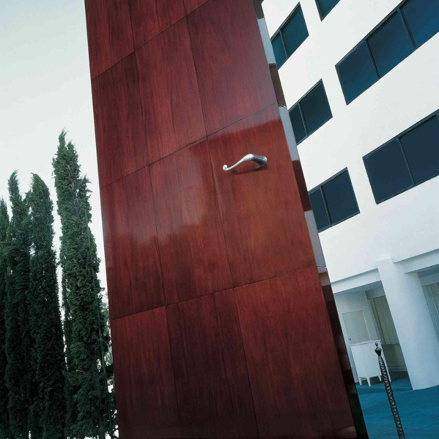 Large, oversized brown door on the exterior of Mondrian Los Angeles