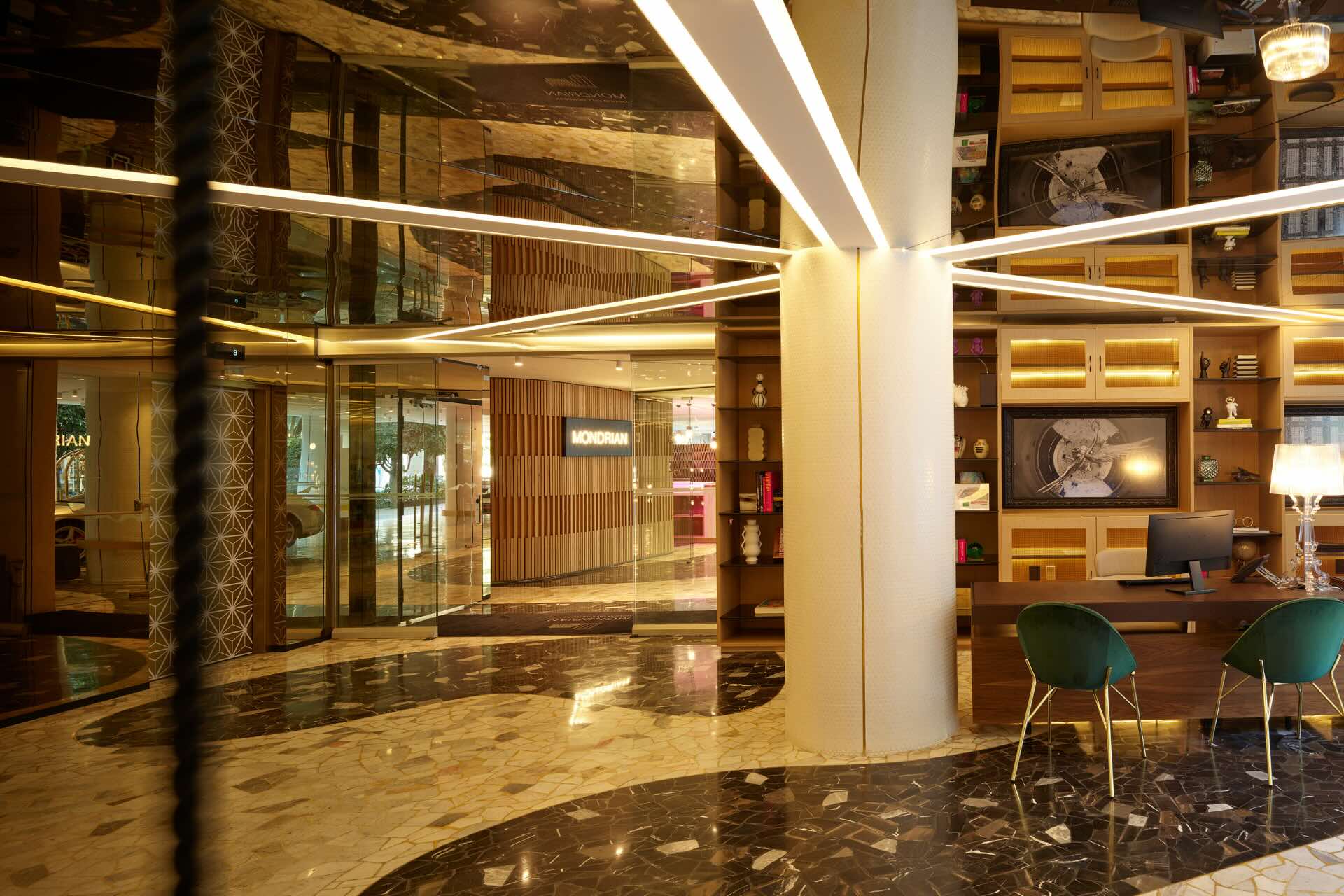 a beautifully decorated lobby with floor to ceiling glass walls and seating area