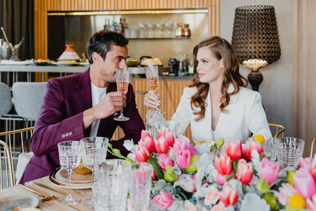 a recently married couple at dinner with beautiful flower table settings