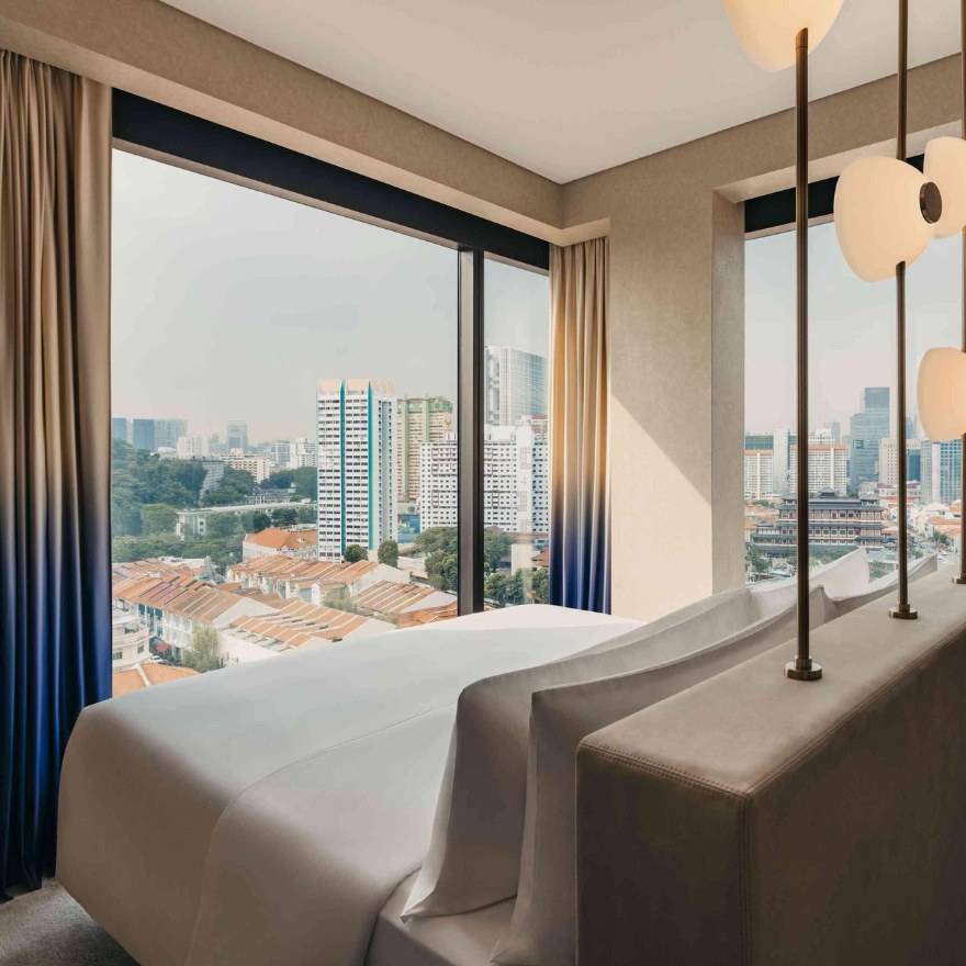 Hotel room with bed with modern lighting overlooking Singapore