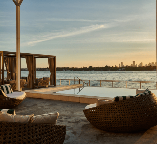 a view of sunset over the bay from the baia pool at mondrian south beach