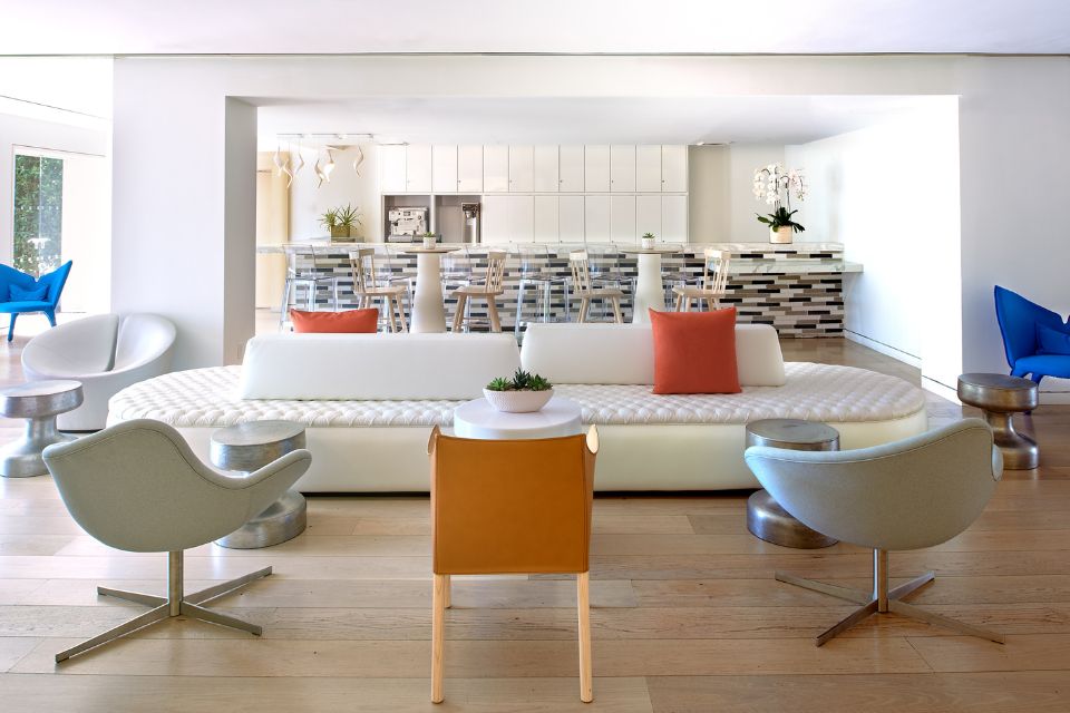 Chic and modern hotel lobby with white sofa and modern chairs surrounding it