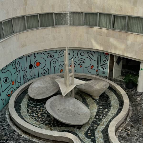 Outdoor courtyard with blue walls and modern seating in grey